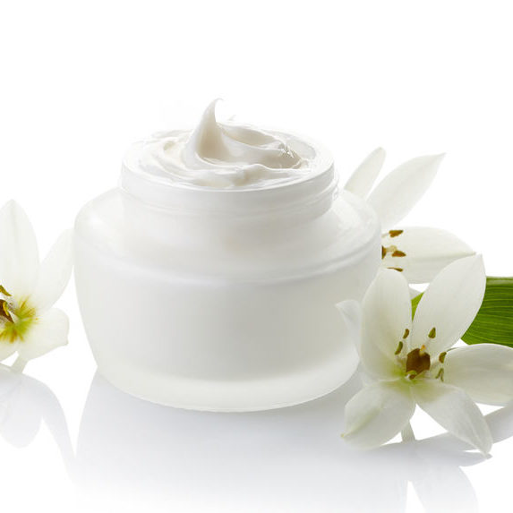 28018917 - white jar of cosmetic cream and flowers isolated on white background